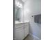 Cozy half bath featuring a crisp white vanity, framed mirror, and neutral wall paint at 18 Green Ridge Ln, Pittsboro, NC 27312