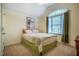 Neutral bedroom featuring a bed with decorative quilt, neutral walls and carpet and bright natural light at 18 Green Ridge Ln, Pittsboro, NC 27312