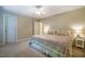 Neutral bedroom featuring large bed with decorative quilt, neutral walls and carpet and bright natural light at 18 Green Ridge Ln, Pittsboro, NC 27312