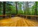 Large outdoor deck surrounded by mature trees, providing a serene and private setting at 18 Green Ridge Ln, Pittsboro, NC 27312