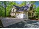 Home with a two car garage, surrounded by green trees at 18 Green Ridge Ln, Pittsboro, NC 27312
