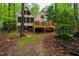 Back of home showing a large deck and wooded privacy at 18 Green Ridge Ln, Pittsboro, NC 27312