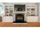 Living room fireplace framed by custom-built shelving and storage at 18 Green Ridge Ln, Pittsboro, NC 27312