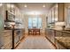 Bright kitchen with stainless steel appliances and cozy eat-in area with window views at 18 Green Ridge Ln, Pittsboro, NC 27312