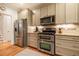 Kitchen showcasing stainless appliances, granite counters, and ample cabinet storage at 18 Green Ridge Ln, Pittsboro, NC 27312