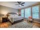 Comfortable main bedroom with a large bed, soft lighting, and a ceiling fan at 18 Green Ridge Ln, Pittsboro, NC 27312