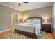 Warm and inviting main bedroom with a comfortable bed, wooden floors and ample natural light at 18 Green Ridge Ln, Pittsboro, NC 27312