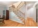 Hardwood staircase featuring wood steps and wrought iron spindles with decorative wood accents, bright natural light at 18 Green Ridge Ln, Pittsboro, NC 27312