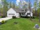 Charming single-Gathering home with manicured lawn, attached garage and inviting front porch at 20 Izuba Day Dr, Timberlake, NC 27583
