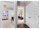 Hallway view of a bedroom and gym with neutral paint and multiple doors at 20 Izuba Day Dr, Timberlake, NC 27583