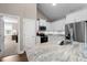 Kitchen boasting granite countertops, stainless steel appliances, white cabinets, and hardwood floors at 20 Izuba Day Dr, Timberlake, NC 27583