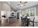 Bright kitchen with stainless appliances, granite counters, an island, and a dining area with deck access at 20 Izuba Day Dr, Timberlake, NC 27583