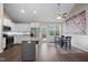 Bright kitchen with stainless steel appliances, granite counters, an island, and an adjacent dining area with backyard access at 20 Izuba Day Dr, Timberlake, NC 27583