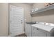 Bright laundry room with modern washer and dryer, and storage shelf at 20 Izuba Day Dr, Timberlake, NC 27583