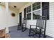 Cozy front porch featuring classic rocking chairs, black shutters, and decorative accents at 20 Izuba Day Dr, Timberlake, NC 27583