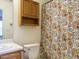 Bright bathroom featuring a vanity, toilet, and a shower with a patterned curtain at 202 Providence Hall Dr, Sanford, NC 27330