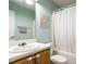 Bathroom with a decorative, carved accent, a modern shower curtain, and a single sink vanity at 202 Providence Hall Dr, Sanford, NC 27330