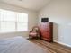 Comfortable bedroom with a window, dresser, TV, and side chair at 202 Providence Hall Dr, Sanford, NC 27330