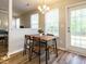 Bright dining area features a wood table, four chairs, and natural light from the window at 202 Providence Hall Dr, Sanford, NC 27330