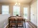 Cozy dining area featuring modern light fixture, wood floors, and natural light from the window at 202 Providence Hall Dr, Sanford, NC 27330