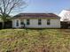 Back exterior features a patio, a grassy area, and large windows for lots of natural light at 202 Providence Hall Dr, Sanford, NC 27330