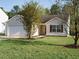 Charming single-story home with a well-manicured lawn, attached garage, and beautiful curb appeal at 202 Providence Hall Dr, Sanford, NC 27330