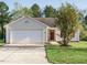 Inviting single-story home with a well-maintained lawn and attached garage in a Gathering-friendly neighborhood at 202 Providence Hall Dr, Sanford, NC 27330