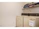 Functional laundry room featuring a washing machine, dryer, and storage shelves at 202 Providence Hall Dr, Sanford, NC 27330