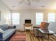 Inviting living room with a ceiling fan, wood floors, neutral walls, and lots of natural light at 202 Providence Hall Dr, Sanford, NC 27330