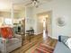 Bright living room flowing into the kitchen with wood floors, neutral walls, and open layout at 202 Providence Hall Dr, Sanford, NC 27330