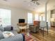 Open-concept living space with modern ceiling fan, neutral walls, wood floors, and ample natural light at 202 Providence Hall Dr, Sanford, NC 27330