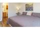 Comfortable main bedroom featuring stylish artwork and a view to the attached bathroom at 202 Providence Hall Dr, Sanford, NC 27330