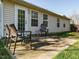 Outdoor patio features a concrete slab, a seating area, and a view of the home's exterior at 202 Providence Hall Dr, Sanford, NC 27330