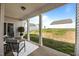 Covered back porch with comfortable seating overlooks the spacious, fenced backyard, perfect for outdoor relaxation at 205 Mcclellan Trl, Mebane, NC 27302