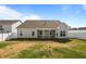 The rear of the home shows a covered patio and large windows overlooking a large, private backyard at 205 Mcclellan Trl, Mebane, NC 27302