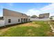Exterior home view showing a spacious backyard with privacy fence and well-maintained lawn, ideal for outdoor enjoyment at 205 Mcclellan Trl, Mebane, NC 27302