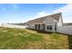 Wide view of the home's rear exterior and sprawling fenced backyard, offering privacy and space at 205 Mcclellan Trl, Mebane, NC 27302