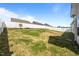Large, fenced backyard with green grass and ample space for outdoor activities and recreation at 205 Mcclellan Trl, Mebane, NC 27302