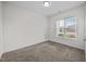 Cozy carpeted bedroom with a window that provides a view of the neighborhood at 205 Mcclellan Trl, Mebane, NC 27302