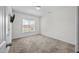 This carpeted bedroom has a window with blinds providing natural light at 205 Mcclellan Trl, Mebane, NC 27302