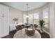 Bright dining area with a modern light fixture, large windows, and a stylish buffet at 205 Mcclellan Trl, Mebane, NC 27302