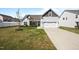 Inviting home featuring a well-manicured lawn, two-car garage, and welcoming entrance at 205 Mcclellan Trl, Mebane, NC 27302