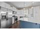 Modern kitchen with stainless steel appliances, white cabinetry, and a blue center island at 205 Mcclellan Trl, Mebane, NC 27302