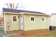 The back of the home showcases durable vinyl siding, white-framed windows, a back entrance, and a well-maintained yard at 2117 Wrenn St, Burlington, NC 27215