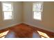 Bedroom featuring hardwood floors and natural light from two windows at 2117 Wrenn St, Burlington, NC 27215