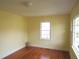 Bright bedroom with hardwood floors, neutral walls, and natural light from the window at 2117 Wrenn St, Burlington, NC 27215