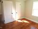 Bedroom with hardwood floors, window, and white trim at 2117 Wrenn St, Burlington, NC 27215