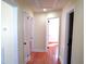 Hallway featuring hardwood flooring and multiple doorways leading to various rooms at 2117 Wrenn St, Burlington, NC 27215