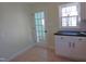 Kitchen featuring white cabinets, black countertops, white appliances, and a tile floor at 2117 Wrenn St, Burlington, NC 27215