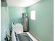 This mint-colored laundry room features modern machines and efficient water heating at 2117 Wrenn St, Burlington, NC 27215